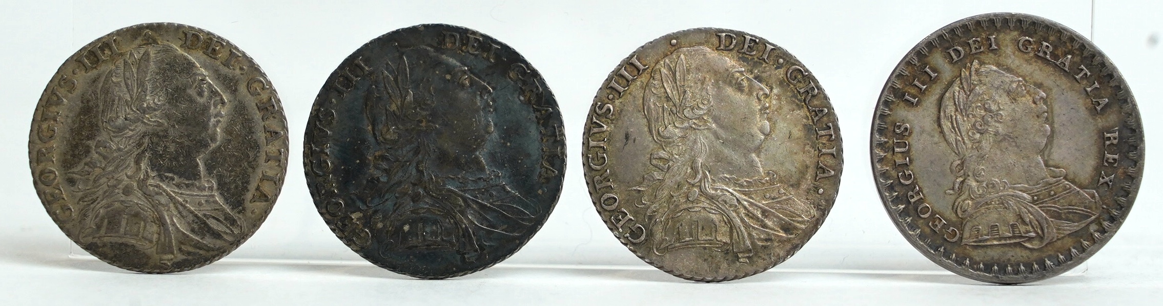 British silver coins, George III, three shilling coins, 1787, good VF to about EF, and Bank token eighteenpence (1S.6D.) 1811, near EF (4)